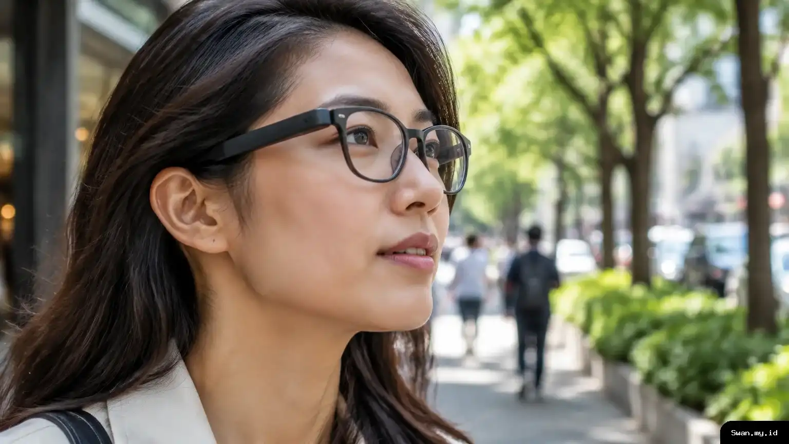 Person wearing smart glasses with open-ear speakers while walking on a city sidewalk